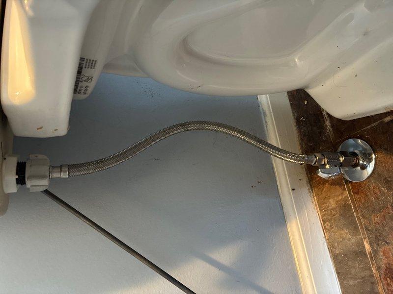 Responded to water leak investigation request due to water staining visible on interior ceiling. Conducted thorough inspection of plumbing fixtures and connections in bathroom area above the affected ceiling. Located source of moisture intrusion at toilet water supply connection point, where extensive corrosion and rust were present on the wall-mounted shut-off valve and surrounding metal escutcheon plate. The braided flexible supply line connection showed significant oxidation and rust halo pattern radiating from the connection point, indicating chronic moisture exposure and potential seepage at the threaded fitting. Documented conditions with photographic evidence showing corroded valve assembly and deteriorated connection components. The rust pattern and moisture damage suggest prolonged intermittent leaking at this fixture supply connection, which would account for the water staining reported on the ceiling below.