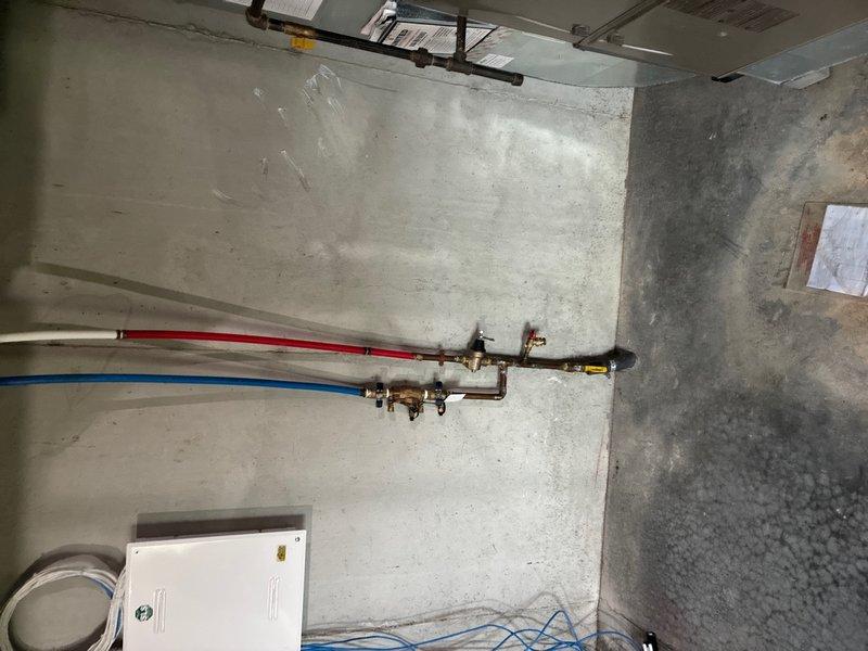Performed estimate for replacement of 12-year-old residential water heater experiencing bottom tank corrosion and active leaking into nearby floor drain. Unit currently operational but showing visible rust deterioration and water seepage requiring immediate replacement to prevent potential flooding or complete system failure.