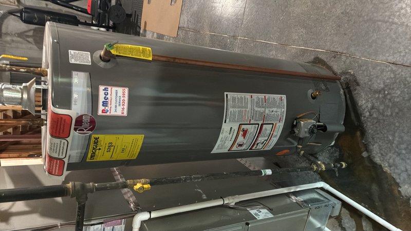 Performed estimate for replacement of 12-year-old residential water heater experiencing bottom tank corrosion and active leaking into nearby floor drain. Unit currently operational but showing visible rust deterioration and water seepage requiring immediate replacement to prevent potential flooding or complete system failure.