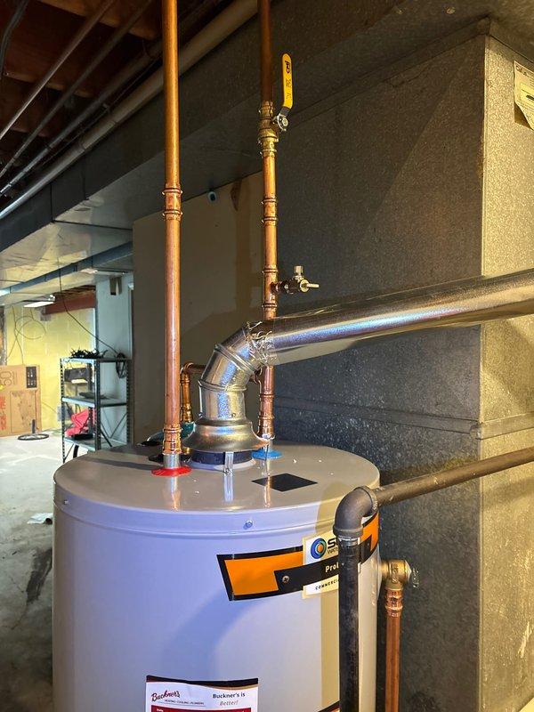 Successfully installed a 50-gallon natural gas water heater in the basement mechanical room. The installation included connecting copper supply lines with brass fittings and shutoff valves for both hot and cold water connections, as well as installing a flexible yellow gas line with proper safety shutoff valve. All plumbing connections were completed to code specifications, and the unit was positioned against the concrete block wall with appropriate clearances for ventilation and service access.