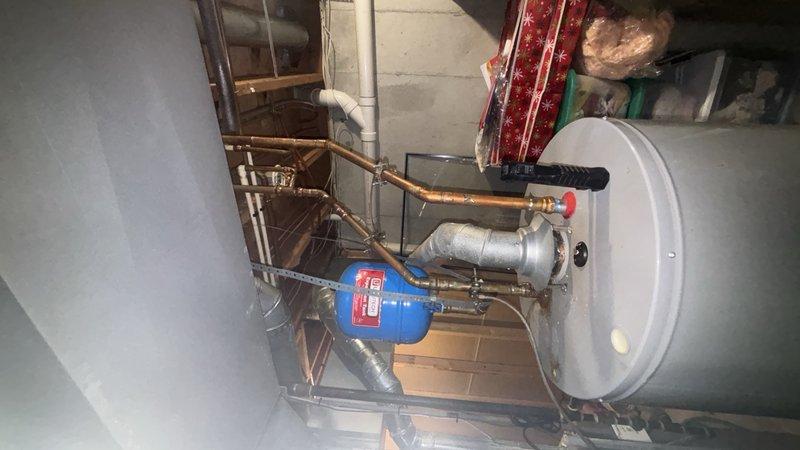 Completed installation of a State 50-gallon gas water heater with 6-year manufacturer warranty in basement utility area. Installed thermal expansion tank with copper piping connections to ensure proper system pressure regulation and code compliance. Replaced existing 3/4" ball valve on main water supply line and installed new 1/4 turn stop valve for humidifier connection. All copper pipe connections were secured with brass fittings, and gas connections were tested for leaks. System was filled, pressurized, and tested for proper operation. Verified adequate venting through existing PVC flue system and confirmed all safety controls functioning correctly. Provided customer with 1-year parts and labor warranty documentation.