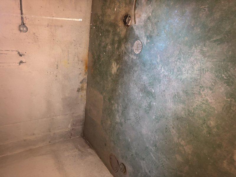 Responded to service call for clogged bathroom sink and basement floor drain. Upon arrival, inspected both fixtures and surrounding plumbing infrastructure. The basement area showed evidence of previous moisture issues with visible water staining on walls and deteriorated concrete surfaces near the floor drain location. Successfully cleared blockages from both the bathroom sink drain line and basement floor drain using appropriate drain cleaning equipment. Verified proper drainage and flow restoration at both fixtures. Noted aging plumbing system with PEX supply lines and older drainage piping showing normal wear patterns consistent with the structure's age.