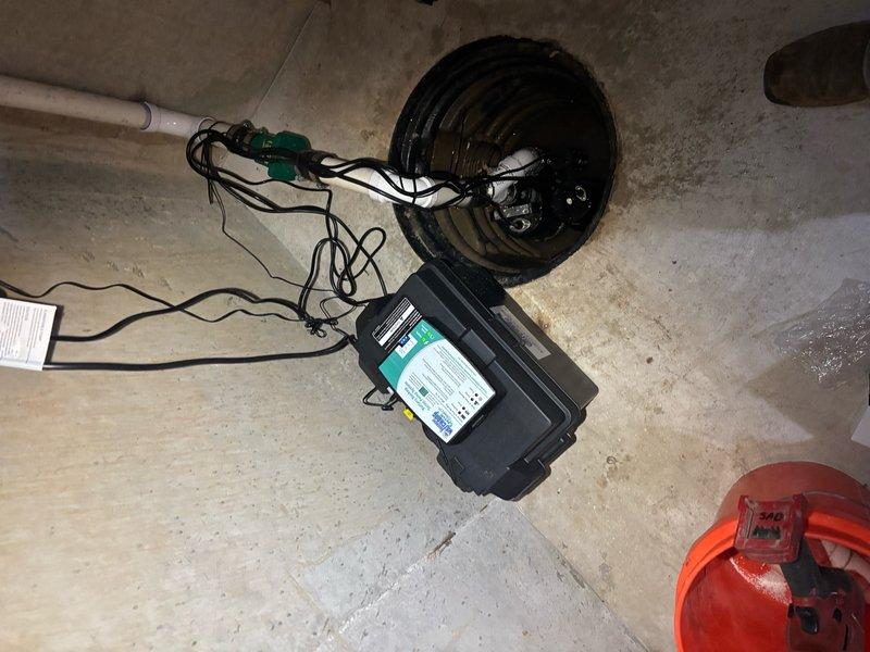 Installed a dual sump pump system in basement utility area, featuring a 1/2 HP energy-efficient permanent split capacitor primary pump with 3,540 GPH capacity at 10 ft. lift and a backup pump system rated at 1,850 GPH at 10 ft. lift. Positioned pumps in ribbed basin liner with float switch assembly, connected discharge piping to existing PVC drainage system, and verified proper operation of both primary and backup units to ensure reliable basement water management.