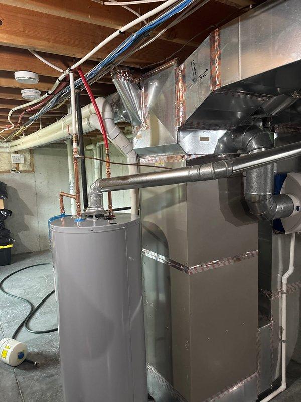 Installed a 50-gallon State gas water heater with thermal expansion tank in the basement utility area. Added a 3/4" ball valve and 1/4 turn stop for humidifier connection. All copper piping connections were completed to manufacturer specifications, and the unit was tested for proper operation with 6-year manufacturer warranty and 1-year parts and labor warranty coverage in effect.