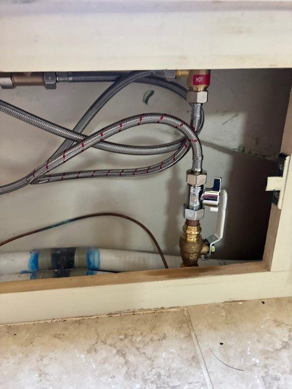 Installed customer-supplied bathtub faucet assembly with brushed metal finish, including center-mounted spout and dual control knobs. Connected supply lines to existing shut-off valves, verified proper water flow and pressure, and tested for leaks at all connection points.