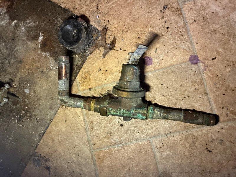 Replaced failed pressure reducer valve in residential garage. Removed heavily corroded original brass valve assembly showing significant oxidation and patina buildup consistent with age of home. Installed new pressure reducer valve with proper brass fittings and connections. Tested system pressure post-installation, confirming proper regulation at approximately 80 PSI as indicated on pressure gauge. All connections secured and system restored to full operation.