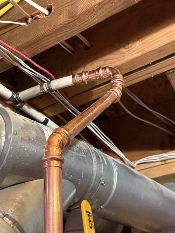 Completed installation of a 50-gallon gas-fired water heater with thermal expansion tank in basement utility space. Installed new copper supply piping connections with proper fittings and joints, secured all plumbing lines to structural framing using appropriate metal strapping per code requirements. Integrated thermal expansion tank into the cold water supply system to protect against pressure buildup from thermal expansion. All gas connections, water supply lines, and pressure relief discharge piping installed according to manufacturer specifications and local plumbing codes. System tested for proper operation, verified gas connections for leaks, and confirmed adequate venting through existing ductwork. Installation completed within 30-minute notice timeframe with all components properly secured and functional.