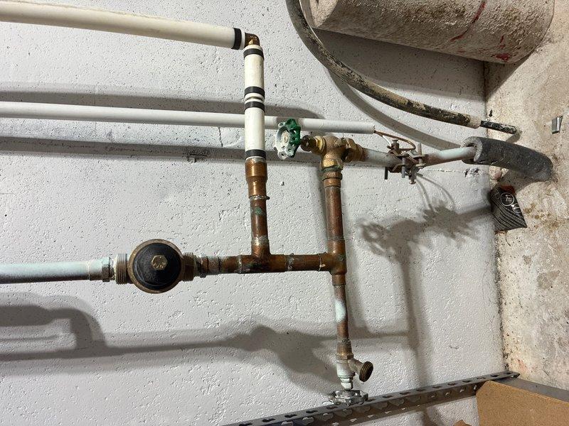 Conducted comprehensive assessment of 16-year-old water heater system in basement to provide replacement estimate. Inspected existing installation including pressure relief valve assembly, temperature and pressure gauge readings, supply line connections, and associated copper and PVC plumbing infrastructure. Documented current system configuration, valve conditions, and mounting arrangements to determine scope of replacement work and ensure proper sizing for new unit installation.