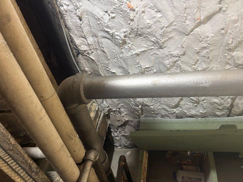 Responded to basement floor drain backflow with paper debris in 114-year-old single-family residence. Accessed main sewer line through basement cleanout and performed comprehensive video camera inspection, revealing significant corrosion and deterioration of cast iron drain piping with rust buildup and mineral deposits throughout the line. Performed mechanical cable cleaning of main drain line to remove debris obstruction and restore proper flow, clearing paper materials and accumulated sediment causing the backflow condition. Advised property owner of advanced pipe deterioration observed during inspection and recommended monitoring for potential future line replacement due to age and condition of original 1912 plumbing infrastructure.
