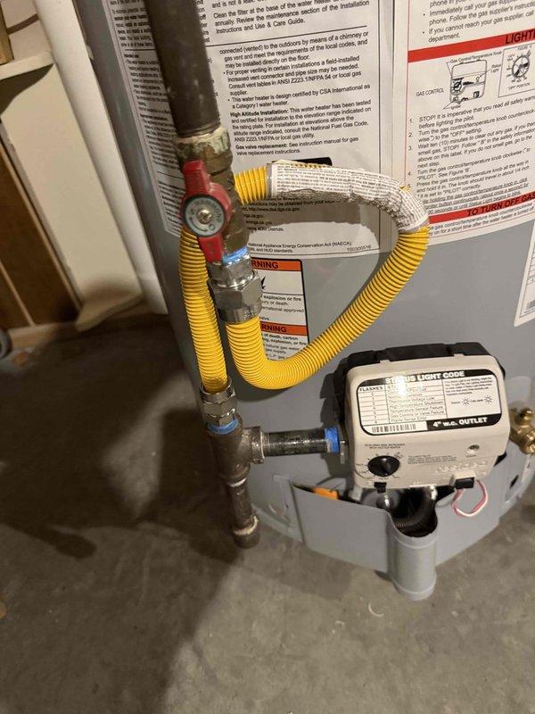 Installed a 40-gallon State ProLine commercial grade gas water heater in the utility area with proper copper piping connections and brass compression fittings at the top of the unit. A blue thermal expansion tank was securely mounted to the wall framing with metal strapping and integrated into the plumbing system. Flexible corrugated stainless steel tubing (CSST) gas lines were connected with a red-handled gas shut-off valve to the black iron gas supply pipe, ensuring safe and code-compliant gas delivery to the unit.