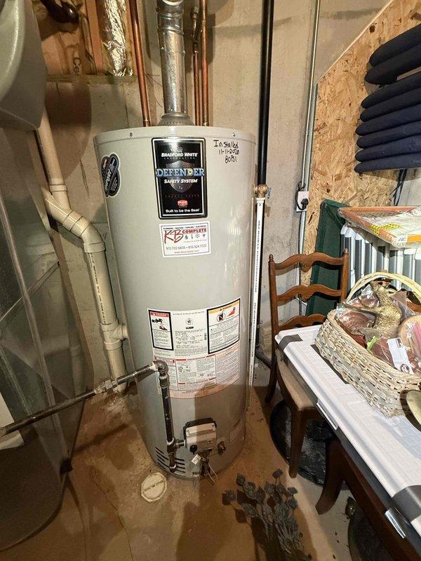 Responded to customer report of water heater producing only lukewarm water in basement. Upon inspection, found Bradford White Defender Safety System tanked water heater with gas control valve set to LOW position. Verified pilot light was lit and burner assembly functional. Adjusted temperature control dial from LOW to HOT setting to restore proper water heating capacity. Confirmed proper operation of gas valve and thermostat controls. Unit returned to normal operating temperature range.