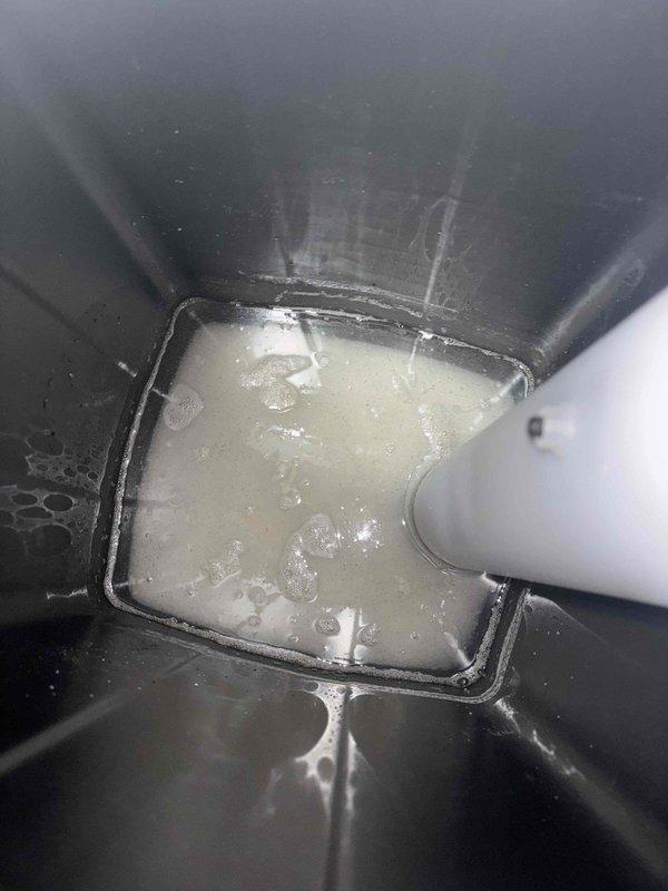 Responded to warranty callback for water pooling beneath recently installed water softener unit. Upon inspection, discovered water accumulation in the drain pan with visible sediment and debris, indicating a drainage issue. The condensate collection tray showed standing water with cloudy discoloration and corrosion along metal edges. Identified drainage obstruction preventing proper water evacuation from the system. Cleared blockage, tested drain flow, and verified proper operation of the water softener drainage system to resolve pooling issue.