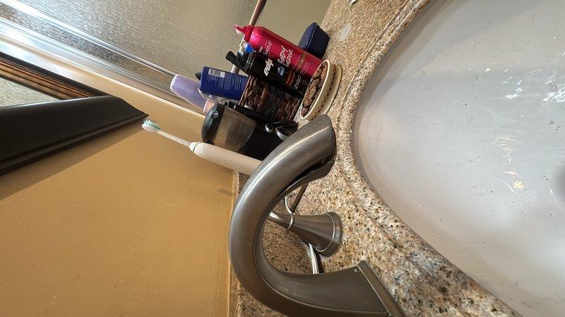 Responded to multiple plumbing issues throughout the residence. Addressed leaking faucet at bathroom vanity with modern single-handle fixture over granite countertop. Serviced malfunctioning shut-off valves that would not close completely, including outdoor shut-off valve. Repaired toilet fill valve assembly to restore proper water refilling function in bowl and tank.