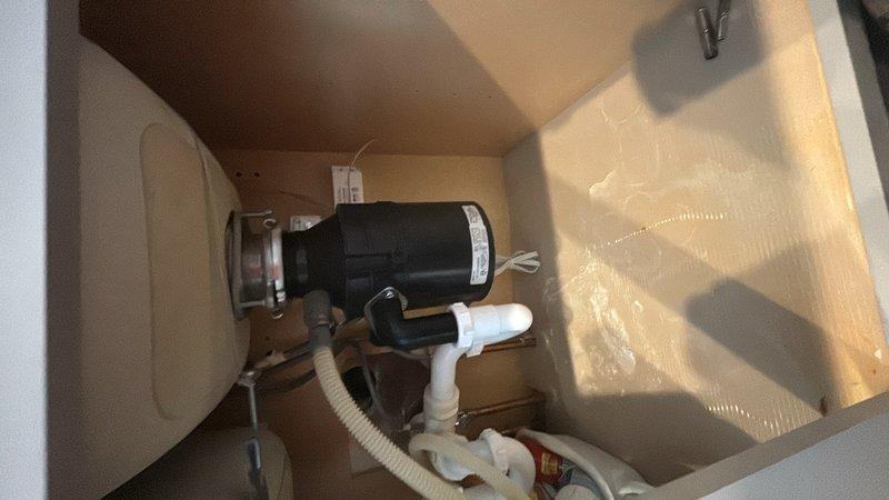 Responded to service call for garbage disposal unit that was humming but not functioning. Upon inspection, diagnosed jammed impeller assembly preventing rotation. Cleared obstruction from grinding chamber and verified proper operation of motor and flywheel. Tested disposal unit under load to confirm full functionality restored.