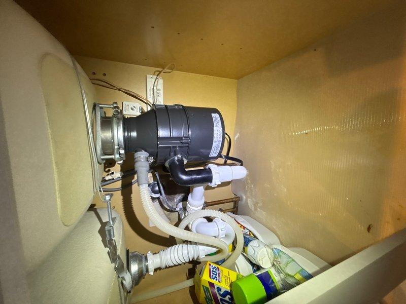 Responded to service call for garbage disposal unit that was humming but not functioning. Upon inspection, diagnosed jammed impeller assembly preventing rotation. Cleared obstruction from grinding chamber and verified proper operation of motor and flywheel. Tested disposal unit under load to confirm full functionality restored.