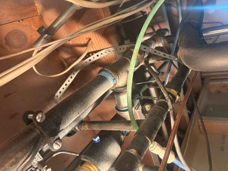 Conducted on-site evaluation for water heater replacement in residential property currently equipped with a commercial-grade tankless unit. Assessed existing installation including gas line connections, venting requirements, electrical wiring, and plumbing configurations in underfloor crawlspace area. Documented copper supply piping, compression fittings, and mounting infrastructure to determine compatibility requirements for both tankless and traditional tank-style replacement options. Evaluated utility space constraints, structural support adequacy, and code compliance considerations for proposed equipment upgrade from commercial to residential-appropriate water heating system.
