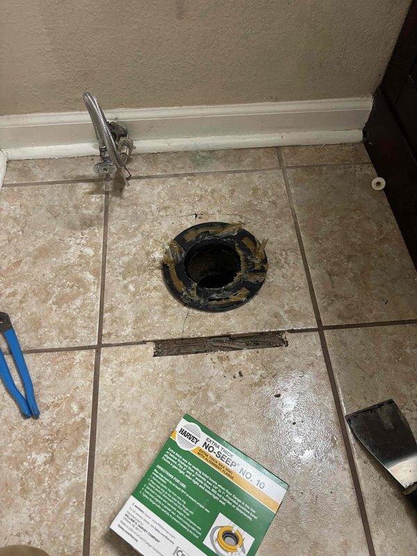 Responded to clogged drain service call and performed toilet removal to access main drain line. Upon inspection, found deteriorated wax ring seal at toilet flange requiring replacement. Removed existing toilet, cleared obstruction from drain opening, and cleaned flange surface. Installed new wax ring seal and reinstalled toilet with proper alignment to flange. Reconnected water supply line to fill valve and tested for leaks. Verified proper flush operation and drainage flow restored to normal function.
