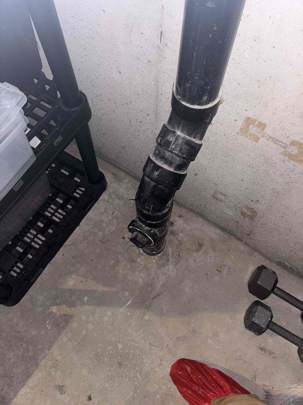 Performed video camera inspection of main sewer line to assess interior pipe condition. Inspection revealed significant scale buildup and residue accumulation on pipe walls throughout the line, with white and grayish deposits coating the interior surfaces. Documentation captured showing compromised flow capacity due to mineral deposits and debris accumulation within the system.