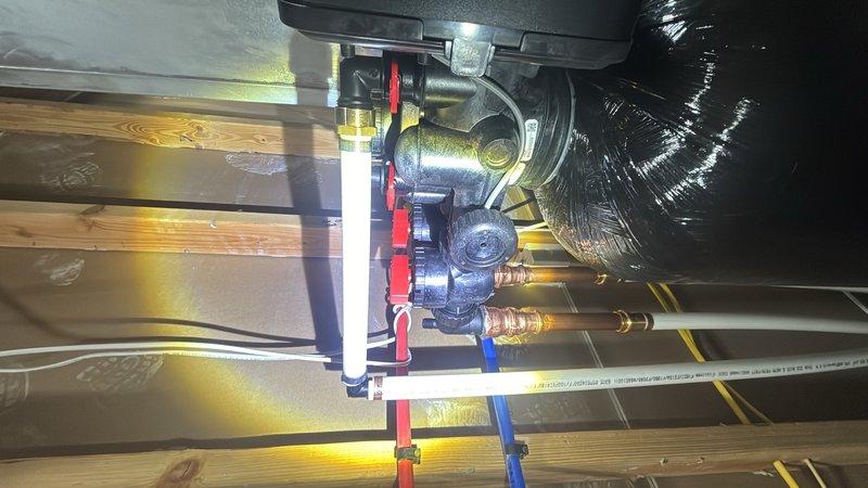 Responded to callback for ongoing leak issue. Upon arrival, inspected attic plumbing system including water heater connections, copper supply lines, pressure relief valve, and associated shut-off valves. Located steady stream leak at brass fitting connections near water heater. Tightened compromised fittings and verified all shut-off valves for proper operation. Documented existing plumbing configuration and HVAC ductwork proximity for reference. Monitored system under pressure to confirm leak resolution before departure.