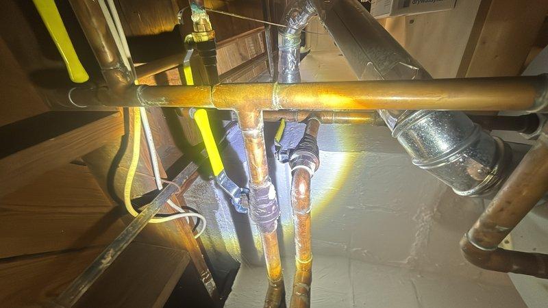 Performed water heater estimate for an 18-year-old unit experiencing pilot light ignition failure. Assessed existing installation, photographed current plumbing configuration including copper supply lines and venting system, and determined unit has reached end of serviceable life requiring replacement.