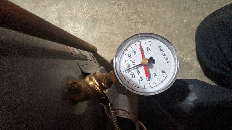 Performed plumbing maintenance visit in utility area. Tested and verified system pressure using calibration gauge, recording reading of approximately 70-80 PSI on main line. Inspected copper and PVC piping runs in mechanical room, checking for proper installation and connections. Documented equipment condition and pipe routing with photographs for service records. All systems operational upon completion of inspection.