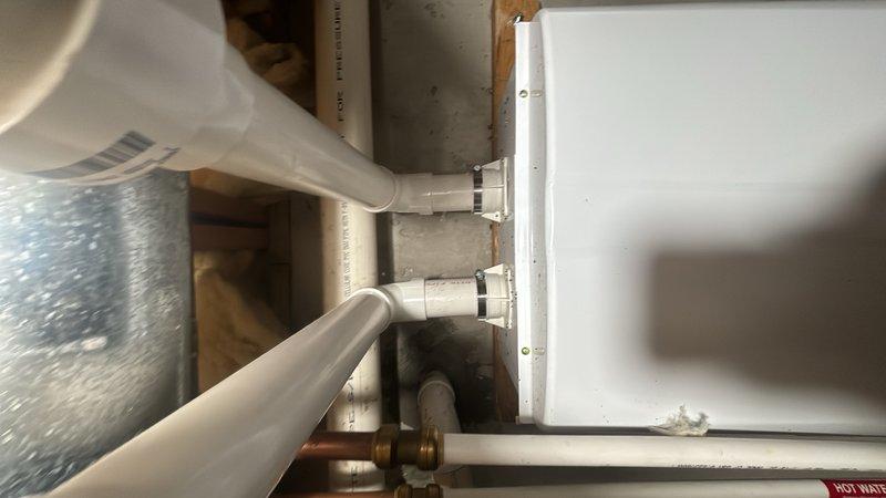Completed preventive plumbing maintenance on tankless water heater system located in basement mechanical space. Inspected unit operation, verified proper function of copper supply lines, brass fittings, and flexible connectors, confirmed hot water distribution through PVC piping network, and documented system condition with photographs showing all components in satisfactory working order.