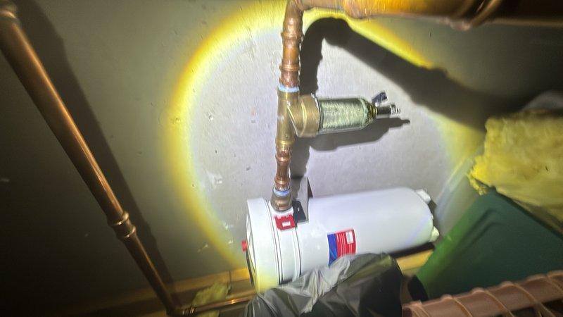 Completed preventive plumbing maintenance on tankless water heater system located in basement mechanical space. Inspected unit operation, verified proper function of copper supply lines, brass fittings, and flexible connectors, confirmed hot water distribution through PVC piping network, and documented system condition with photographs showing all components in satisfactory working order.