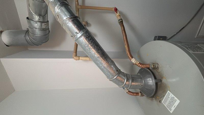 Completed on-site evaluation of existing gas water heater installation in condominium utility closet. Assessed current 40-gallon gas water heater unit, including inspection of gas supply lines, copper water connections with shutoff valves, and flexible vent ducting system routed to exhaust. Documented existing plumbing configuration, clearance requirements, and ventilation setup to provide accurate replacement estimate for new tanked water heater installation.