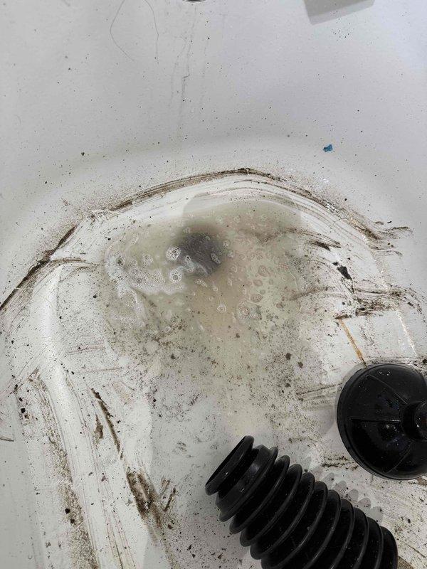 Responded to a clogged bathtub drain on the second floor hallway. Upon arrival, found the tub basin with significant standing water and visible debris accumulation in the drain opening. Utilized a mechanical drain auger to clear the obstruction, successfully removing a substantial amount of organic matter, hair, and fibrous buildup from the drain line. The blockage was completely cleared, restoring proper drainage function to the fixture.
