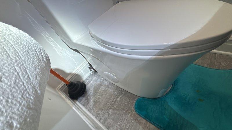 Completed installation of customer-supplied one-piece toilet in residential bathroom. Removed existing toilet fixture, installed new wax ring seal, and properly set and secured the new toilet to the floor flange. Connected water supply line, tested for proper operation and verified no leaks at base or supply connection.
