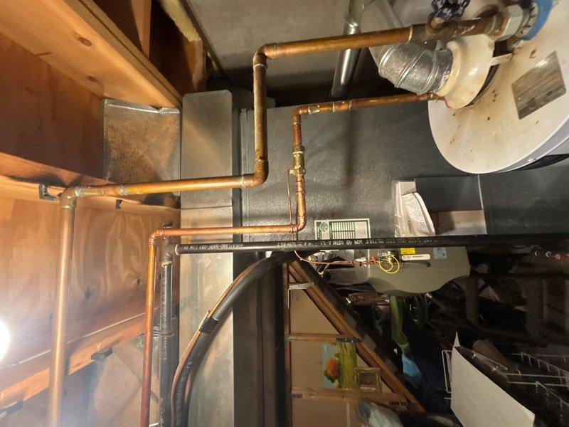 Responded to water leak at hot water heater location. Upon inspection, identified compromised water supply line connection near the unit. Repaired the leaking water line using appropriate copper fittings and connections. Verified all piping connections were secure and tested system for proper operation with no additional leaks detected upon completion.