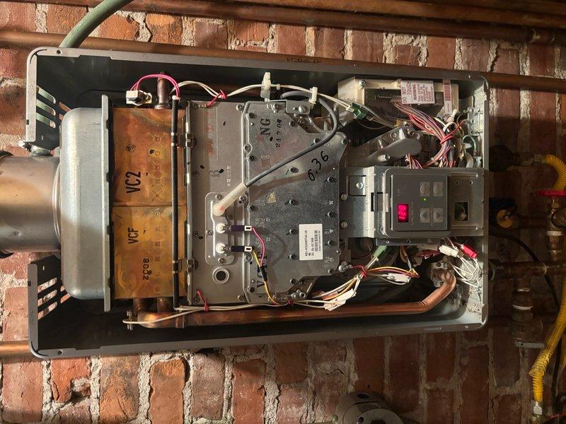 Responded to callback for heating unit displaying error code 11 related to ignition failure, following previous repair completed on 4/29. Upon arrival, accessed the second-floor unit and removed cover panel to inspect internal components and electrical connections. Examined ignition system, control board, wiring harnesses, and gas valve assembly. Verified proper electrical connections at terminal blocks, checked wire integrity including pink and yellow leads at bus bars, and inspected control module functionality. Documented internal condition of heat exchanger, burner assembly, and all safety controls with photographs. Tested system operation and confirmed unit firing properly with no error codes present.