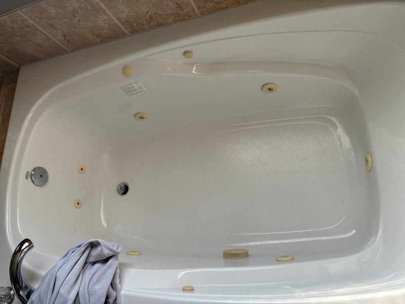 Completed complimentary plumbing inspection of bathroom fixtures including jetted bathtub and handheld shower assembly. Documented existing conditions of all plumbing components, verifying jet functionality, drain operation, and spray head connections for future reference and maintenance planning.