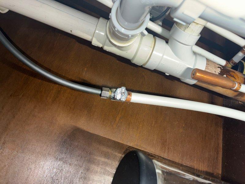 Responded to emergency water leak in kitchen area where supply line connected to shut-off valve had ruptured, causing active water discharge. Upon arrival, immediately located and isolated the water source to prevent further damage. Inspected the failed connection point at the shut-off valve and assessed the condition of surrounding plumbing components including flexible braided supply lines, PVC drain assembly, and associated fittings. Removed the compromised water line and replaced the faulty connection with new supply line and proper fittings. Verified all connections under the sink cabinet were secure and tested the system for leaks. Confirmed proper water flow and pressure restoration to the fixture while ensuring no additional leaks were present at valve connections or throughout the supply line assembly.