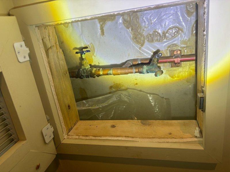 Conducted comprehensive assessment of 10-year-old water heater located in basement to provide replacement estimate. Unit currently operational but showing signs of age-related deterioration, including visible mineral deposits and rust staining on concrete floor beneath base, indicating previous or ongoing minor seepage. Evaluated existing plumbing connections, access panel configuration with shutoff valves, and installation conditions to determine scope of replacement work and ensure proper sizing and compatibility for new water heater installation.