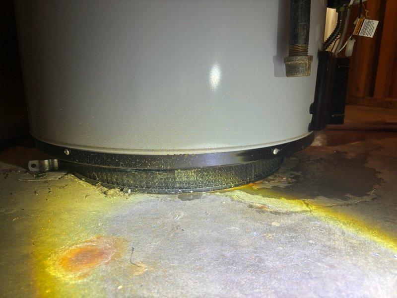 Conducted comprehensive assessment of 10-year-old water heater located in basement to provide replacement estimate. Unit currently operational but showing signs of age-related deterioration, including visible mineral deposits and rust staining on concrete floor beneath base, indicating previous or ongoing minor seepage. Evaluated existing plumbing connections, access panel configuration with shutoff valves, and installation conditions to determine scope of replacement work and ensure proper sizing and compatibility for new water heater installation.
