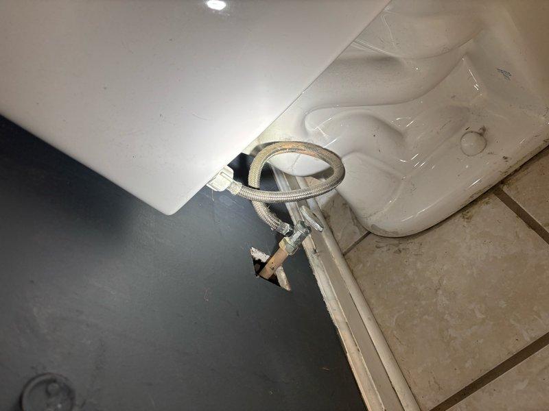 Responded to service call for kitchen sink plumbing requiring installation of new shut-off valves and drain system modifications. Replaced existing cut-off valves with new fixtures, including toilet supply line shut-off that was previously leaking. Updated drain configuration by consolidating multiple drain lines into a single drain assembly beneath the kitchen sink. All plumbing connections were tested for proper operation and verified leak-free. Work completed in finished basement area with full accessibility to plumbing fixtures.