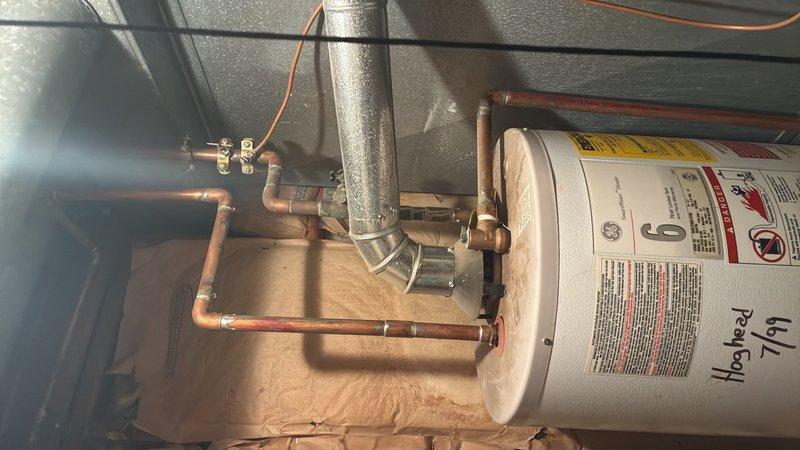 Conducted on-site assessment of existing water heater system and provided estimate for replacement of 40-gallon residential water heater. Evaluated current installation including copper supply lines, electrical grounding components, venting configuration, and connection points to determine scope of replacement work. Documented existing plumbing infrastructure, including brass fittings, shutoff valves, and metallic flue pipe assembly for proper sizing and compatibility with new unit installation.
