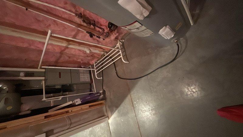 Performed comprehensive inspection and flush service on a 10-year-old tanked water heater located in basement utility room. Drained sediment buildup from tank, verified pressure relief valve operation with gauge reading within normal parameters, and reflushed system to ensure optimal water heater performance and efficiency.