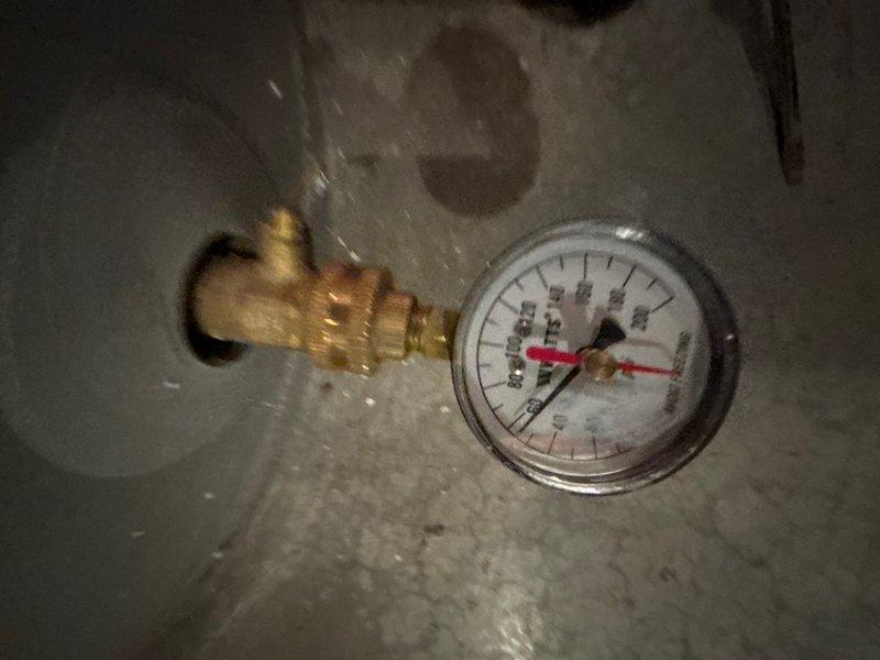 Performed comprehensive inspection and flush service on a 10-year-old tanked water heater located in basement utility room. Drained sediment buildup from tank, verified pressure relief valve operation with gauge reading within normal parameters, and reflushed system to ensure optimal water heater performance and efficiency.