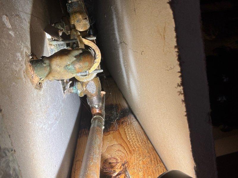 Responded to a bathtub drain repair where the existing drain assembly had severely corroded and deteriorated. Upon inspection, found the tub drain fitting had rotted away with significant oxidation and green patina visible on the brass components. Assessed the drain assembly to determine if replacement could be accomplished by removing and replacing only the internal tub drain strainer, or if complete drain assembly replacement including the waste and overflow system would be necessary. Proceeded with repair work on an hourly basis due to the uncertain extent of corrosion damage and potential complications with removing the deteriorated fittings. Documented the corroded valve assembly and bathroom fixture conditions prior to beginning work, noting the age and wear of the existing plumbing installation.