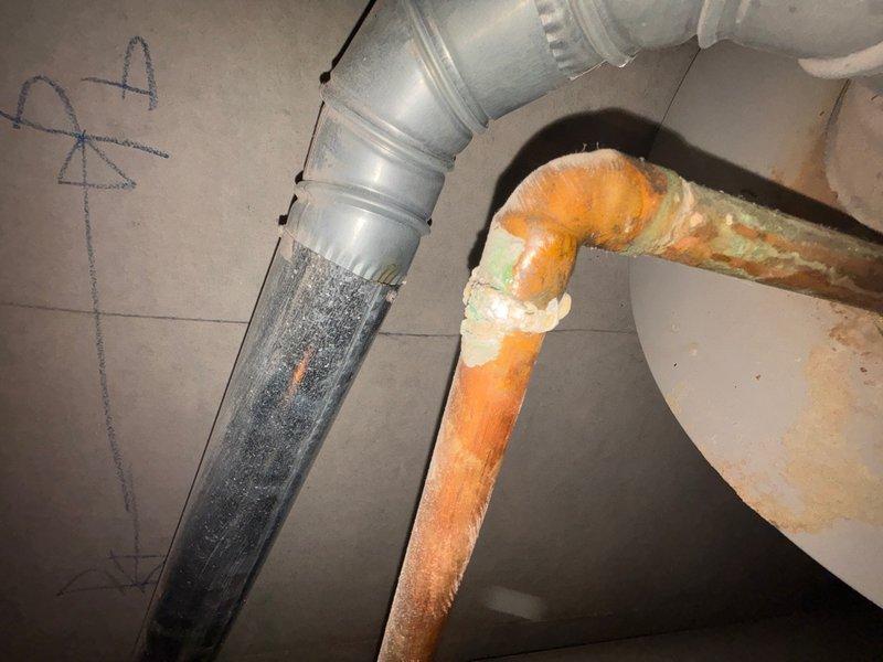 Responded to callback for no hot water issue. Upon inspection, found significant corrosion and deterioration on water heater piping system, including rust damage on curved copper sections and degraded insulation. Documented condition of water heater installation, including corroded pipework, electrical connections, and overall unit status for assessment and repair recommendations.