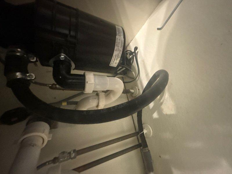 Completed installation of customer-supplied garbage disposal unit in kitchen area and performed water softener system inspection. Unboxed new disposal motor assembly, verified all mounting hardware and electrical connections, and secured unit beneath kitchen sink according to manufacturer specifications. Water softener system checked and confirmed operating within normal parameters with all connections secure and no leaks detected.