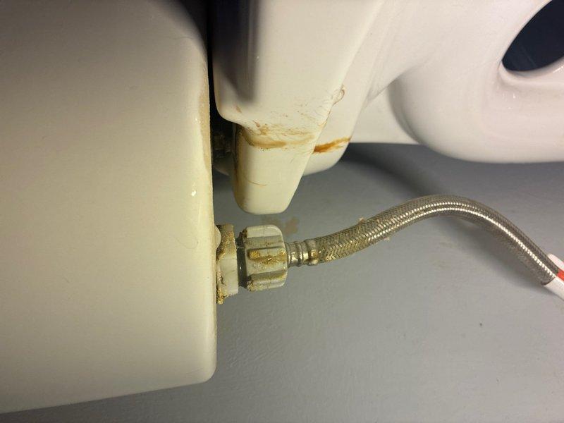 Responded to plumbing repair call for leaking toilet supply line and bathroom faucet. Upon inspection, discovered corroded connection at toilet tank inlet valve with visible water staining and mineral deposits on ceramic fixture and surrounding area. Replaced deteriorated braided stainless steel supply line and brass connection fitting, ensuring proper seal at tank inlet valve. Addressed bathroom faucet leak by inspecting and repairing faulty components. Tested all connections under pressure to verify leak elimination and proper water flow. Photographed damaged components and completed repairs for documentation purposes.