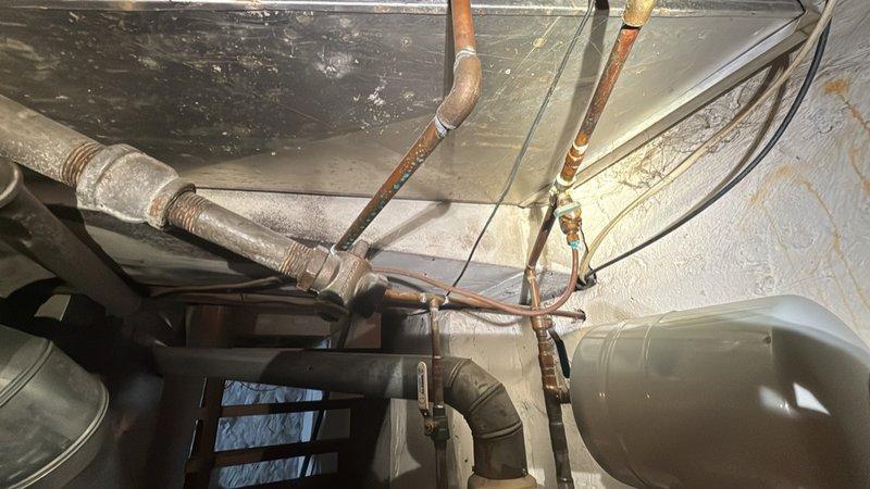 Performed routine maintenance flush on a tanked water heater located in the basement. The unit is under 10 years old and was serviced during the scheduled 8-12 time window. Drained sediment buildup from the tank to maintain heating efficiency and extend equipment lifespan.