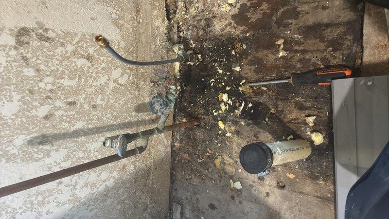Responded to plumbing service call at 57-year-old residential property reporting water leakage from crawlspace into kitchen area. Upon inspection, identified deteriorated plumbing conditions in crawlspace beneath kitchen with significant water damage to flooring and surrounding surfaces. Installed elbow fitting on kitchen drain line to accommodate cabinetry drawer installation and resolve clearance issue. Addressed leaking pipe connections contributing to moisture infiltration. Documented extensive water damage and deterioration to crawlspace surfaces for homeowner records.