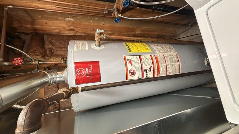 Responded to service call for water heater that would not relight. Upon arrival, inspected gas-fired water heater installation in basement utility area. Examined pilot light assembly, thermocouple, and gas control valve for proper operation. Verified gas supply line connections and tested for adequate gas pressure at the unit. Checked all copper piping connections, pressure relief valve, and shut-off valves for proper installation and function. Successfully restored water heater to operational status and confirmed unit was heating water properly before departure.
