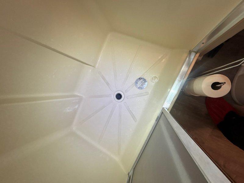 Completed comprehensive whole-home plumbing inspection at customer's request with no reported issues or concerns. Performed thorough visual assessment of all accessible plumbing fixtures, supply lines, drain systems, and water heating equipment throughout the residence. Inspected bathroom facilities including shower base with center drain configuration, verified proper drainage function and fixture condition. Examined water heater installation, confirmed equipment specifications and compliance labeling, and noted recent installation date of June 2024 on unit documentation. All visible copper supply piping, drainage systems, and plumbing fixtures found to be functioning properly with no leaks, corrosion concerns, or immediate service needs identified at time of inspection.