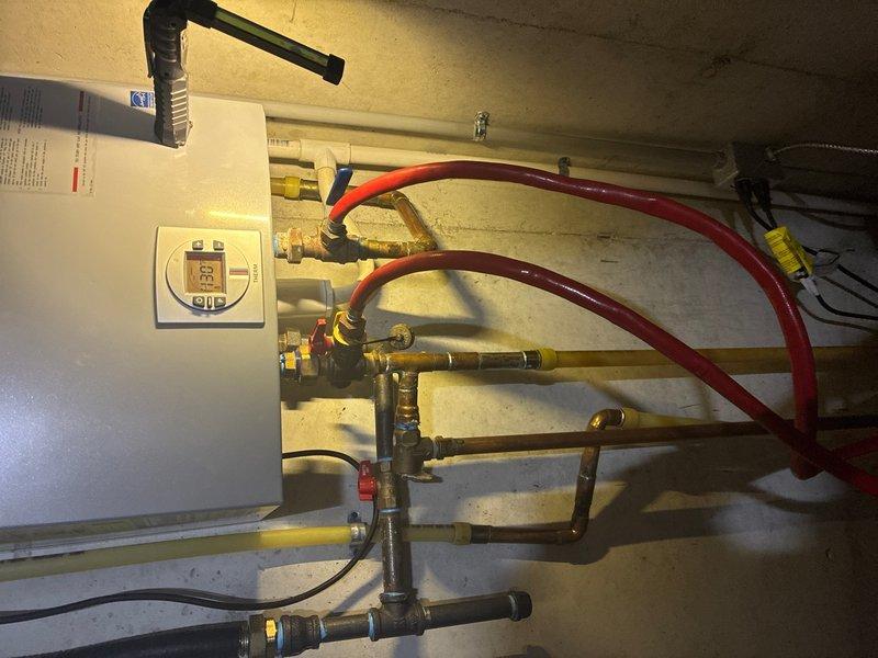 Performed routine maintenance flush on tankless water heater unit located in basement. Connected circulation hoses to isolation valves and flushed system with descaling solution to remove mineral buildup and maintain optimal performance and efficiency.
