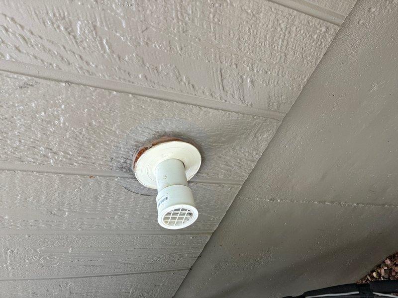 Responded to follow-up service call regarding concerns about tankless water heater installation. Conducted thorough inspection of unit and associated venting system. Documented existing installation with photographs showing PVC vent termination through ceiling with visible rust staining around flange, indicating potential moisture intrusion or condensate issues. Examined mechanical room setup including white tankless unit with PVC exhaust piping, support brackets, and gas line connections. Assessed venting configuration, pipe routing, and proper securing of all components to ensure compliance with manufacturer specifications and local code requirements.
